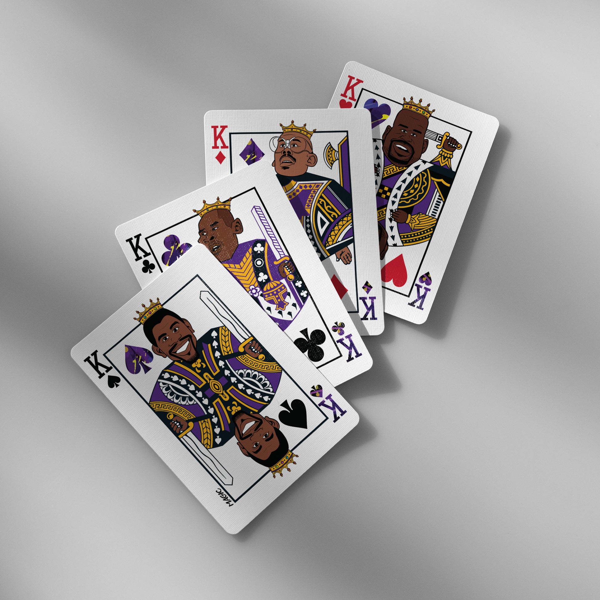 Close-up of Lakers playing cards showing King face cards with iconic player caricatures